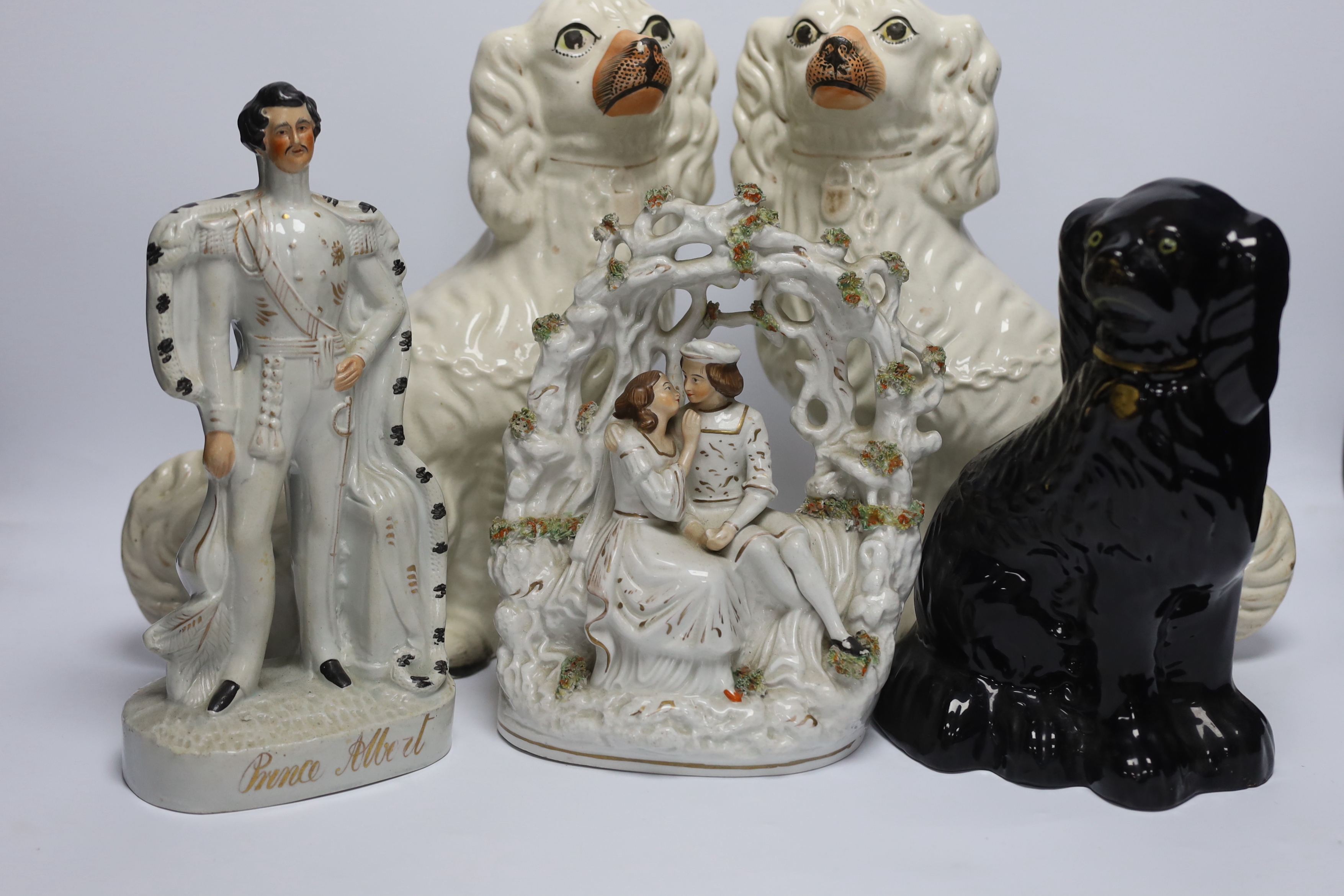 A mixed collection of Staffordshire figure groups to include various spaniels, Prince Albert figure, further courting couples and other bocage groups
